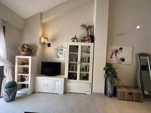 a living room with a television and a white cabinet at Villanueva Golf- Cozy 2 Bedrooms -Puerto Real, Cádiz in Puerto Real
