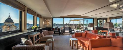 a hotel lobby with couches and tables and windows at Hassler Roma in Rome
