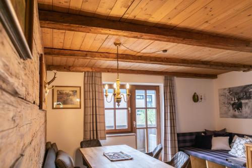a dining room with a table and a couch at Appartements Kirchenwirt in Kirchberg in Tirol