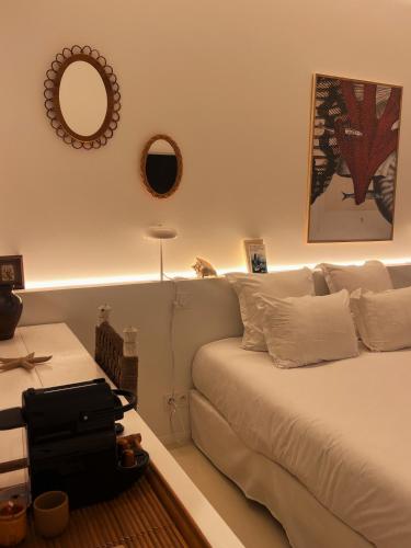 a bedroom with a bed and a mirror on the wall at Hotel La Potiniere in Hyères