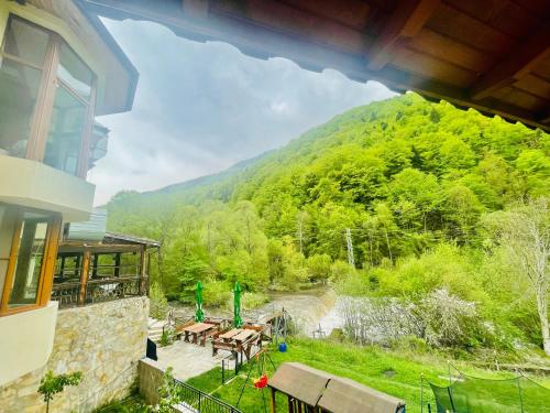 a house with a view of a mountain at Family Hotel Gorski Kut in Rilski Manastir