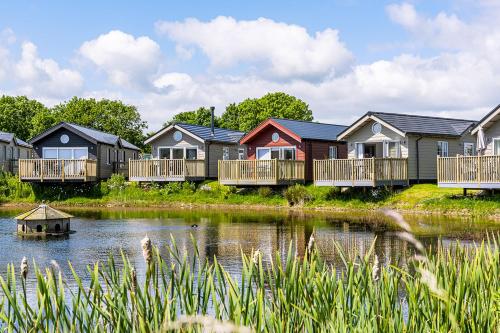 a row of houses next to a body of water at The Bay Filey in Filey