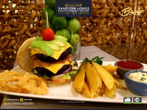 a sandwich and french fries on a white plate at Sandton Lodge Rivonia in Johannesburg