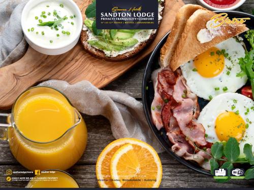 a breakfast plate of eggs bacon and toast with a glass of orange juice at Sandton Lodge Rivonia in Johannesburg