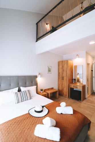 a bedroom with a large bed with two towels on a table at Sithon Diamond Suites 1 in Nikiti