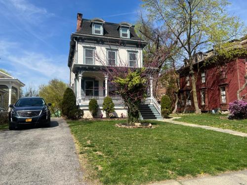 a house with a car parked in front of it at 2Br Private Victorian Apartment in City location on half acre Sleeps 5 in Poughkeepsie