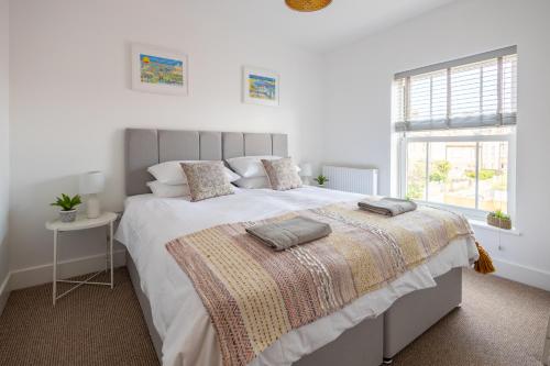 a bedroom with a large bed with two pillows on it at The Ramey in Sheringham