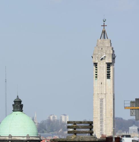 a tall building with a cross on top of it at Hôtel Belvue in Brussels