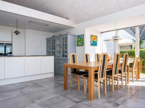 a kitchen and dining room with a wooden table and chairs at 8 person holiday home in Odder-By Traum in Odder