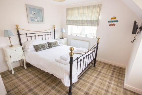 a bedroom with a large bed and a window at The Bay Filey in Filey