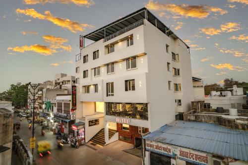 a tall white building on a city street at THE MANGAL VIEW RESIDENCY - A Luxury Boutique Business Hotel in Udaipur