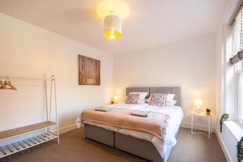 a bedroom with a large bed with two pillows at The Ramey in Sheringham