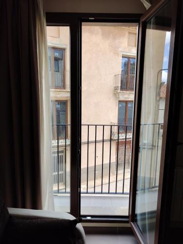 an open window with a view of a balcony at Aparthotel Castellfort in Castellfort