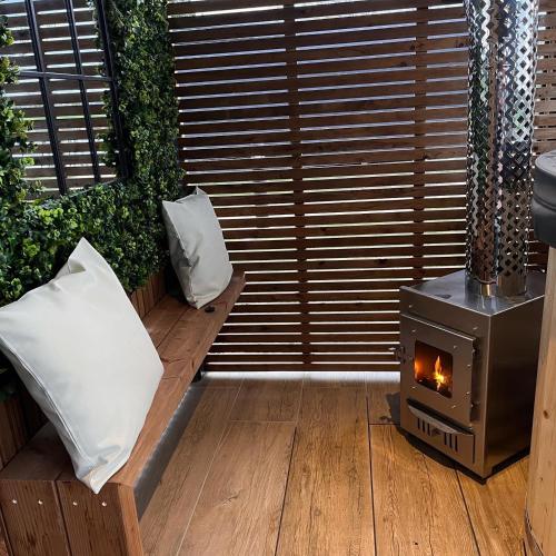 a room with a wood stove and a couch at New Farm Cheshire Holidays in Winsford