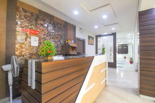 a lobby with a counter and a stone wall at The panachi in Mathura