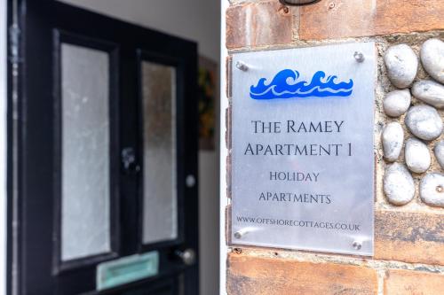 a sign on a brick wall next to a door at The Ramey in Sheringham