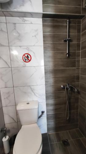 a bathroom with a toilet and a shower at First line apartment in Flogita