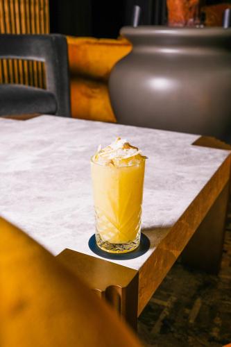 a drink sitting on top of a table at The Municipal Hotel Liverpool - MGallery in Liverpool
