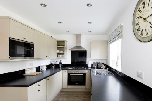 a kitchen with a large clock on the wall at The Bay Filey in Filey