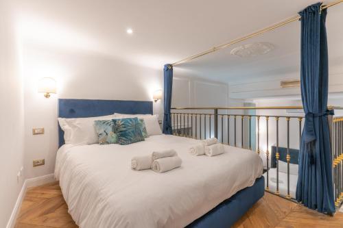 a bedroom with a large bed with towels on it at Duomo Smart Suites in Milan