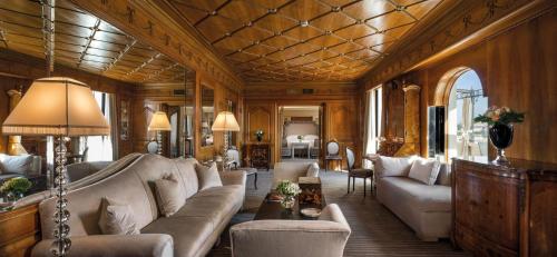 a living room with a couch and a table at Hassler Roma in Rome