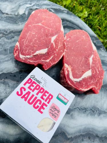 two pieces of beef on a table with a book at New Farm Cheshire Holidays in Winsford