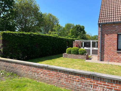 a brick retaining wall next to a house at Villa Jean in Blankenberge