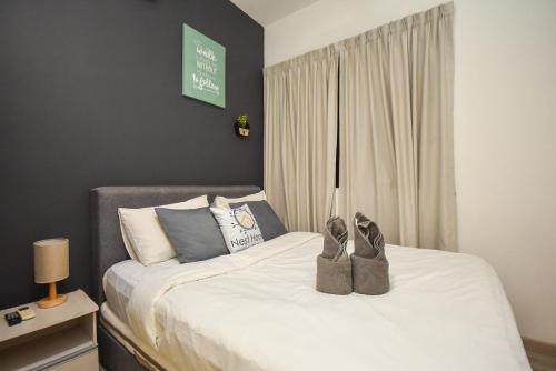 a bedroom with a bed with shoes on it at Midvalley Southkey Mosaic Suite by Nest Home in Johor Bahru