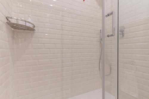 a shower with a glass door in a bathroom at Duomo Smart Suites in Milan