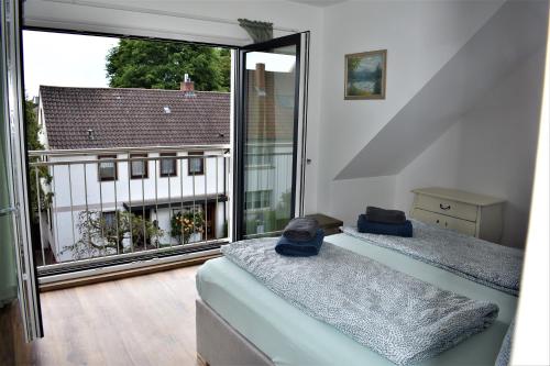 two beds in a room with a large window at Heiligenbergblick in Heidelberg