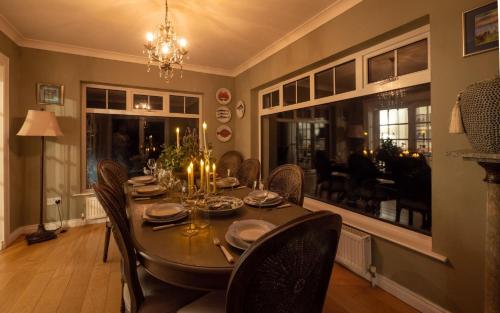 a dining room with a table and chairs and a dining room at Luxurious 5 bedroomed home with sea view close to beach in Lettermacaward