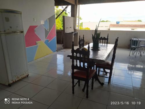 a dining room with a table and chairs on a tile floor at indaiá Pousada - Posto da Mata-BA in Pasto da Mata