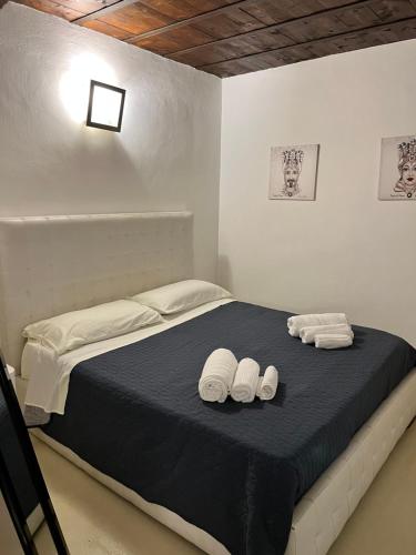 1 dormitorio con 1 cama con 2 toallas en Abitare Ortigia, en Siracusa