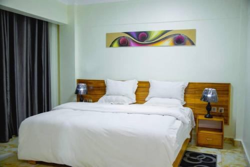 En eller flere senge i et værelse på Mountain View Hotel & apartment