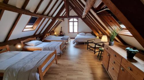 a room with four beds in a attic at La Ferme de Wolphus in Zouafques