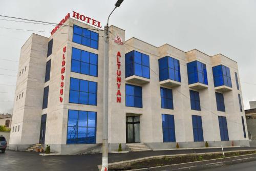 a building with a hotel sign on top of it at Altunyan Hotel in Yerevan