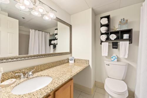 a bathroom with a sink and a toilet and a mirror at The Grand Hotel in Ogunquit