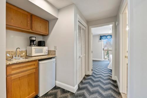 a kitchen with a sink and a microwave at The Grand Hotel in Ogunquit