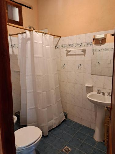 a bathroom with a toilet and a sink at Hostería Plaza Chica Tilcara in Tilcara