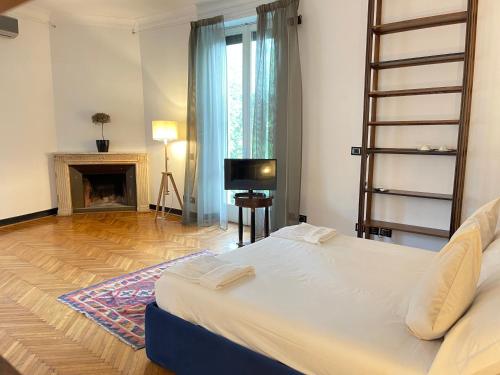 a bedroom with a large bed and a fireplace at ELEGANT ROOMS PARIOLI in Rome