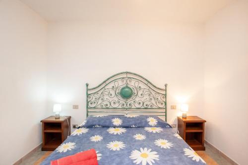 a bedroom with a bed and two night stands at Appartamento Acacia in Cala Liberotto