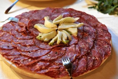 a steakurger with a flower on top of it with a fork at Agriturismo Bellavista in San Miniato