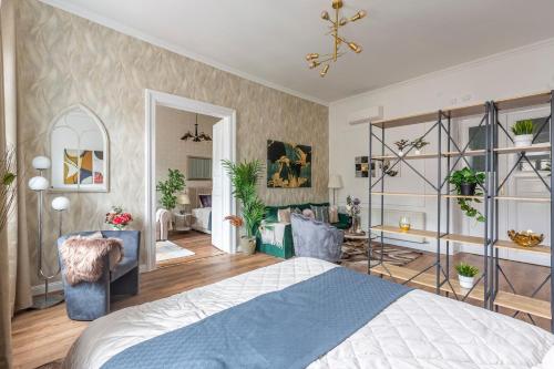 ein Schlafzimmer mit einem Bett und ein Wohnzimmer in der Unterkunft Luxurious Art Deco Residence in the Heart of Budapest in Budapest