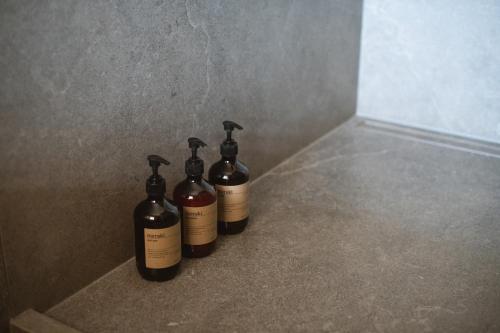 three bottles of wine sitting on the floor at Villa Cavaion in Cavaion Veronese