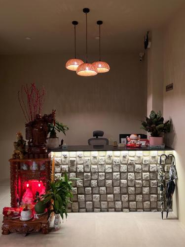 a counter in a room with plants and lights at escVACA - Your Stay in Mui Ne in Mui Ne