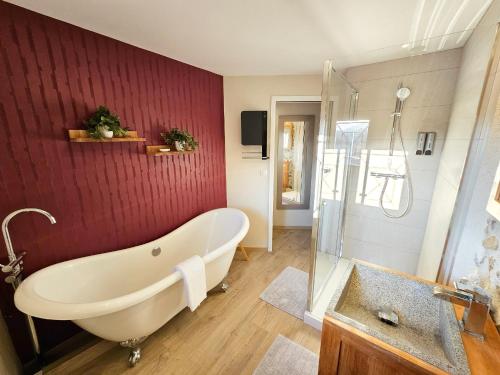 a bathroom with a bath tub and a shower at Le Micocoulier in Montesquieu