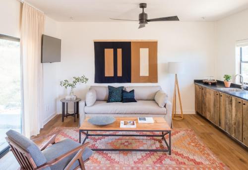 a living room with a couch and a table at Contigo Ranch Fredericksburg in Fredericksburg