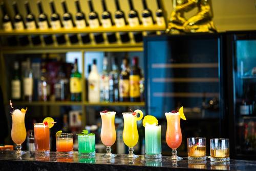 a group of cocktails in vases on a bar at Mercure Riga Centre in Rīga