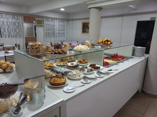 a buffet line with many different types of food at Tulipa Hotel in Foz do Iguaçu