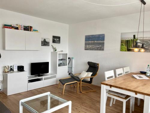 uma sala de estar com uma mesa e uma sala de jantar em Anton-Gunther-Str 16 em Wangerooge